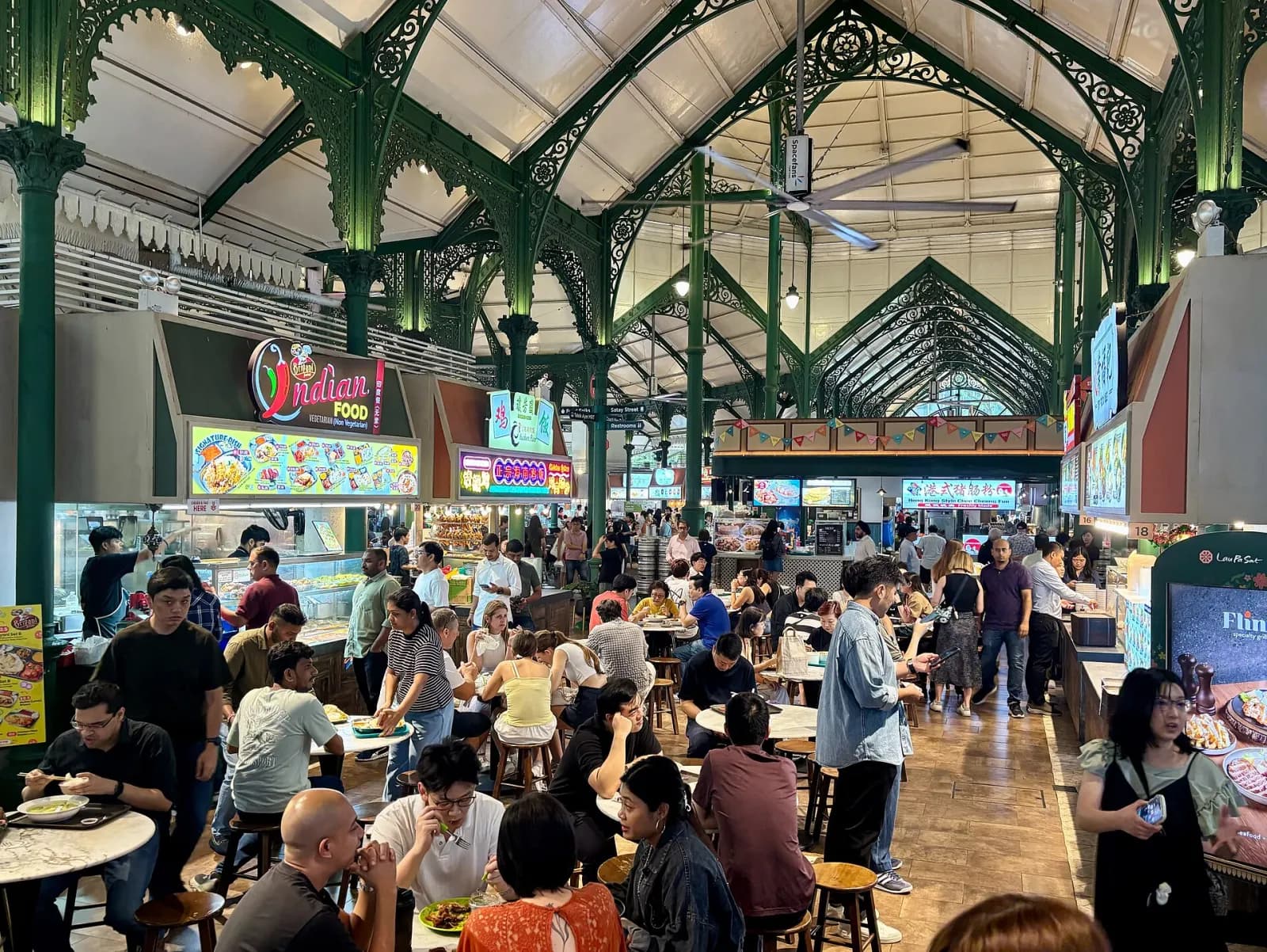 Interior dining area of Lau Pa Sat food market in Singapore.