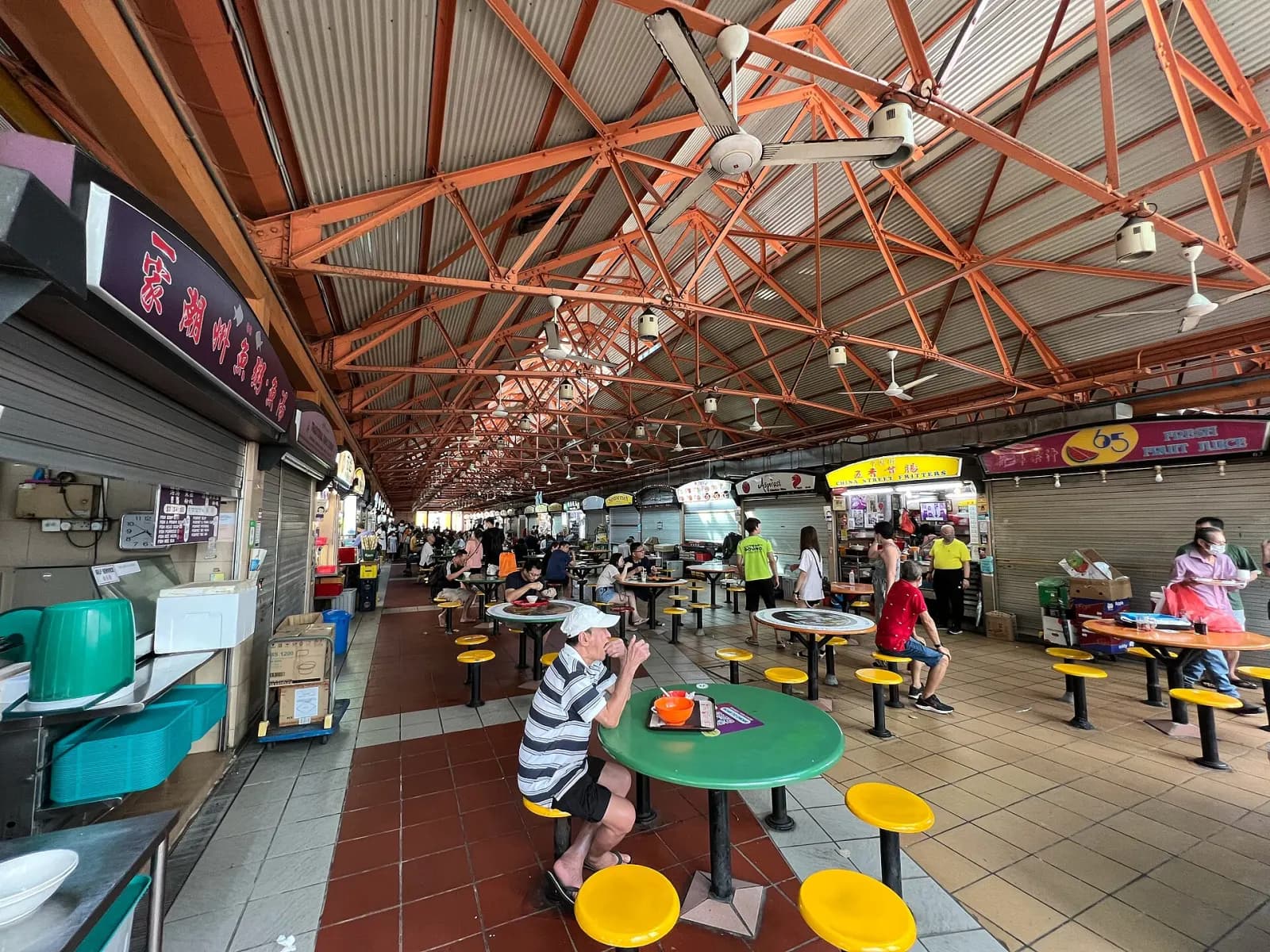 Customers and food stalls inside Maxwell Food Centre in Singapore.