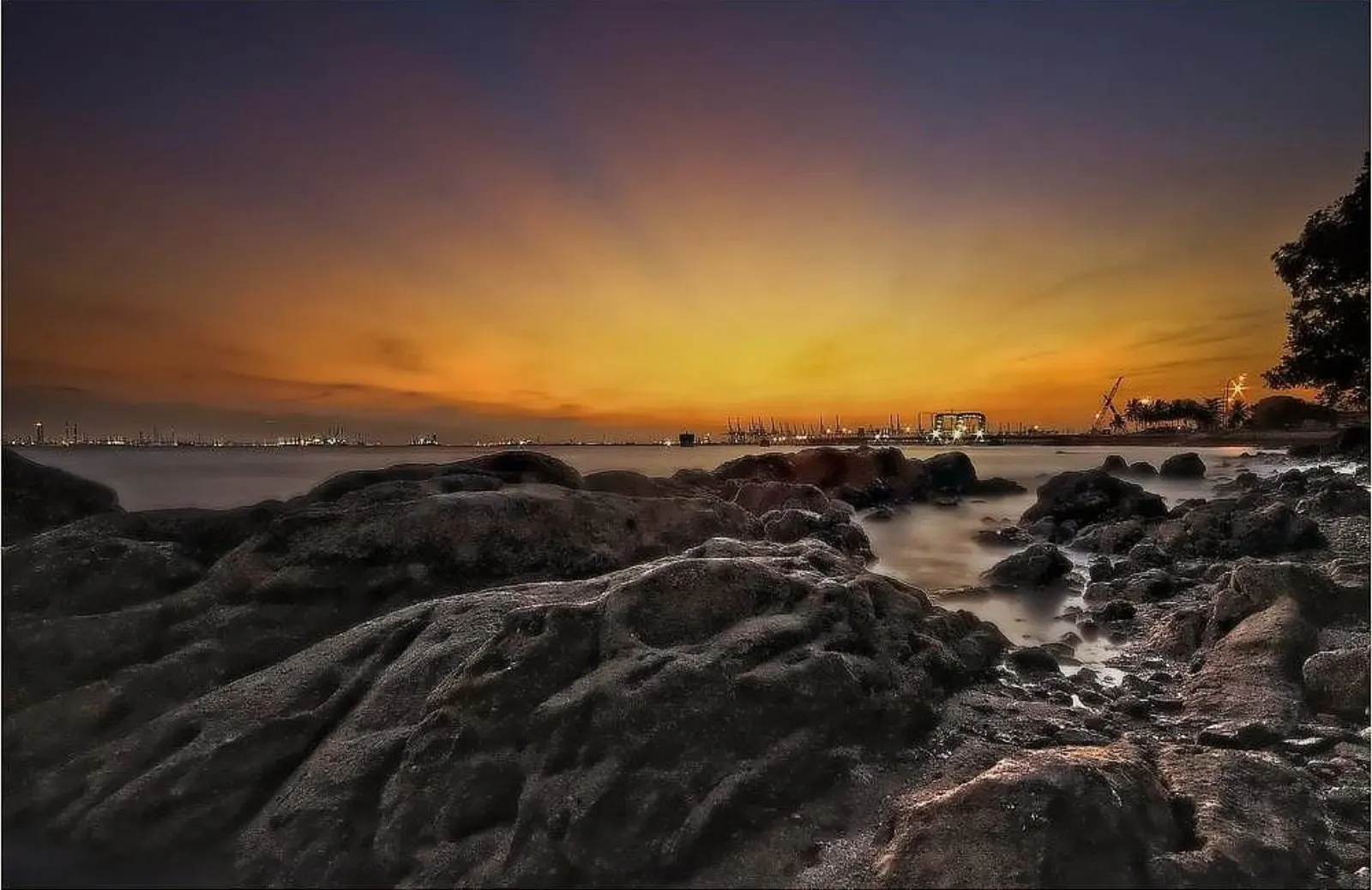 Sunset over the water at Labrador Beach in Singapore.