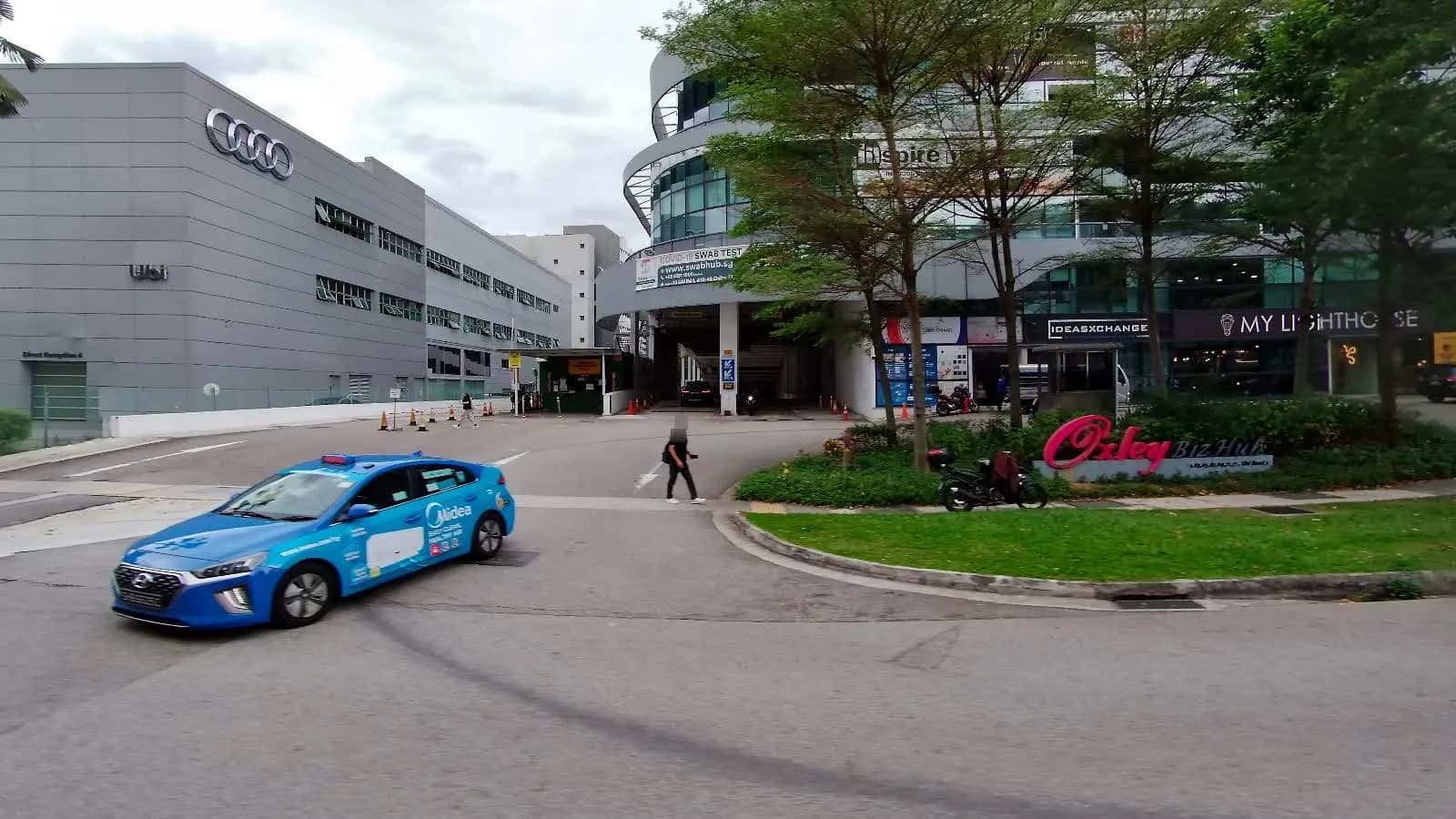 Entrance to Oxley Bizhub 2 at 62 Ubi Road 1, with the building sign visible.