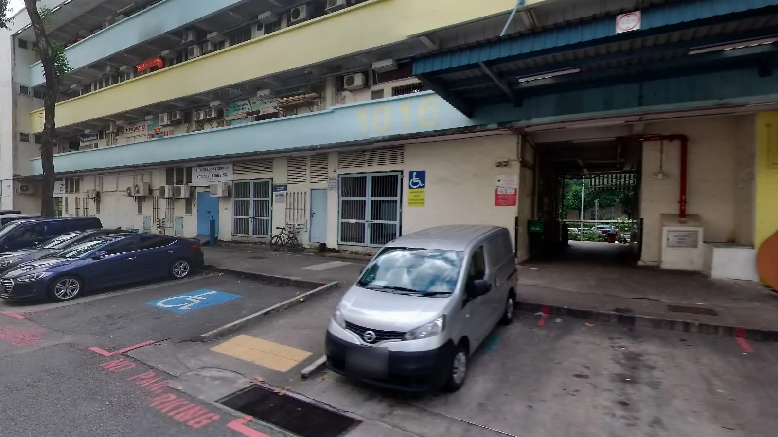 Block 1016 at Geylang East Industrial Estate, with the building number visible.