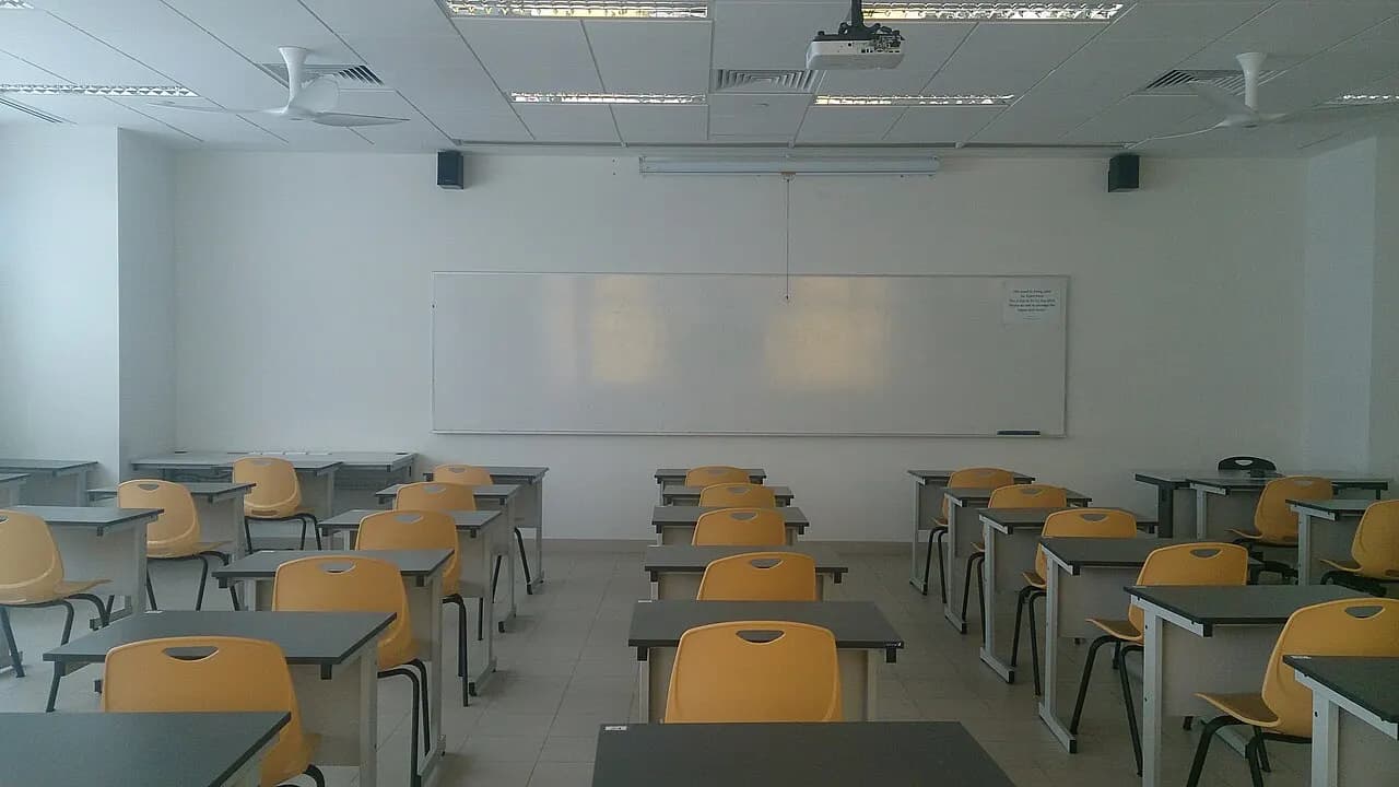Rows of tables and chairs in a classroom at ITE Headquarters in Singapore.