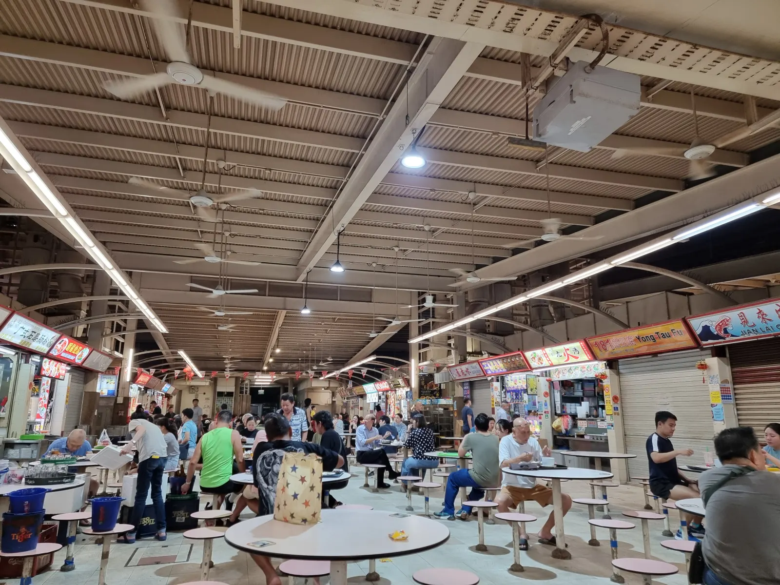 Customers and food stalls inside Redhill Market and Food Centre in Singapore.