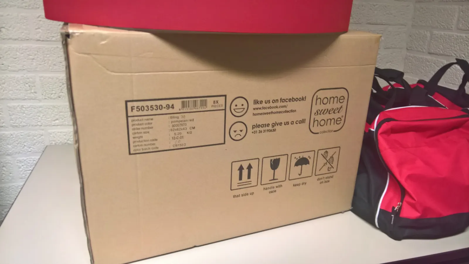 A cardboard moving box marked Home sweet home.