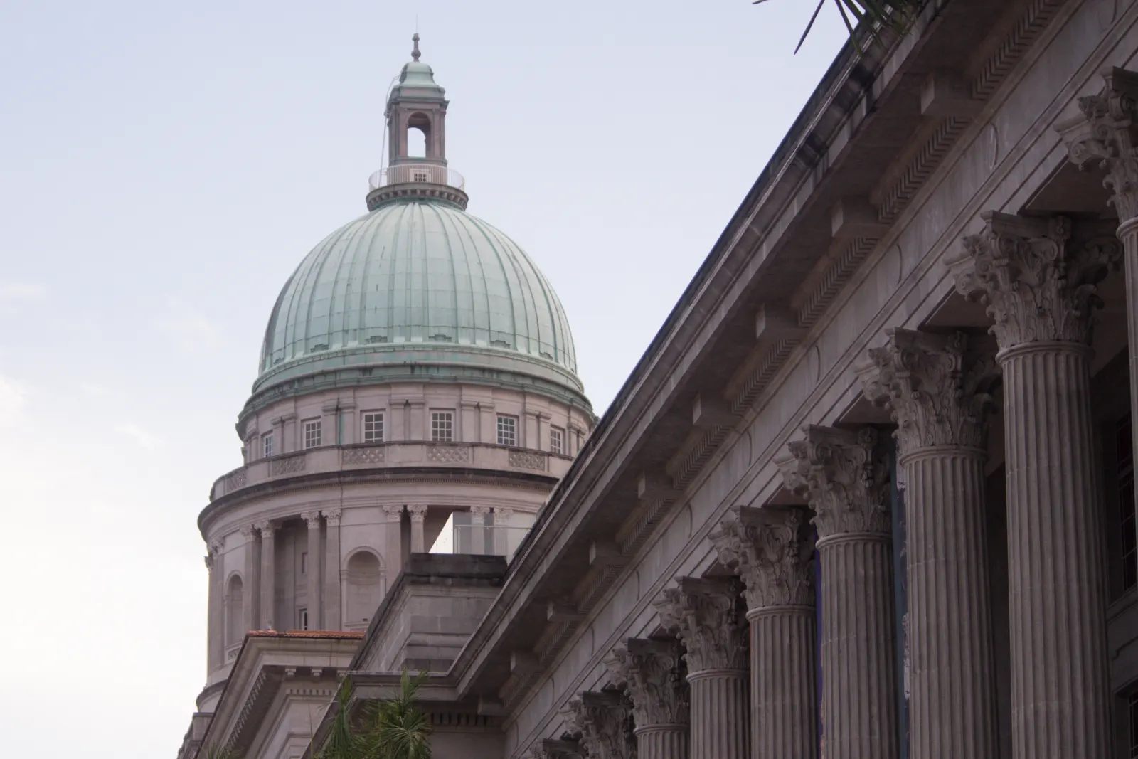 The upper facade and dome of National Gallery Singapore.