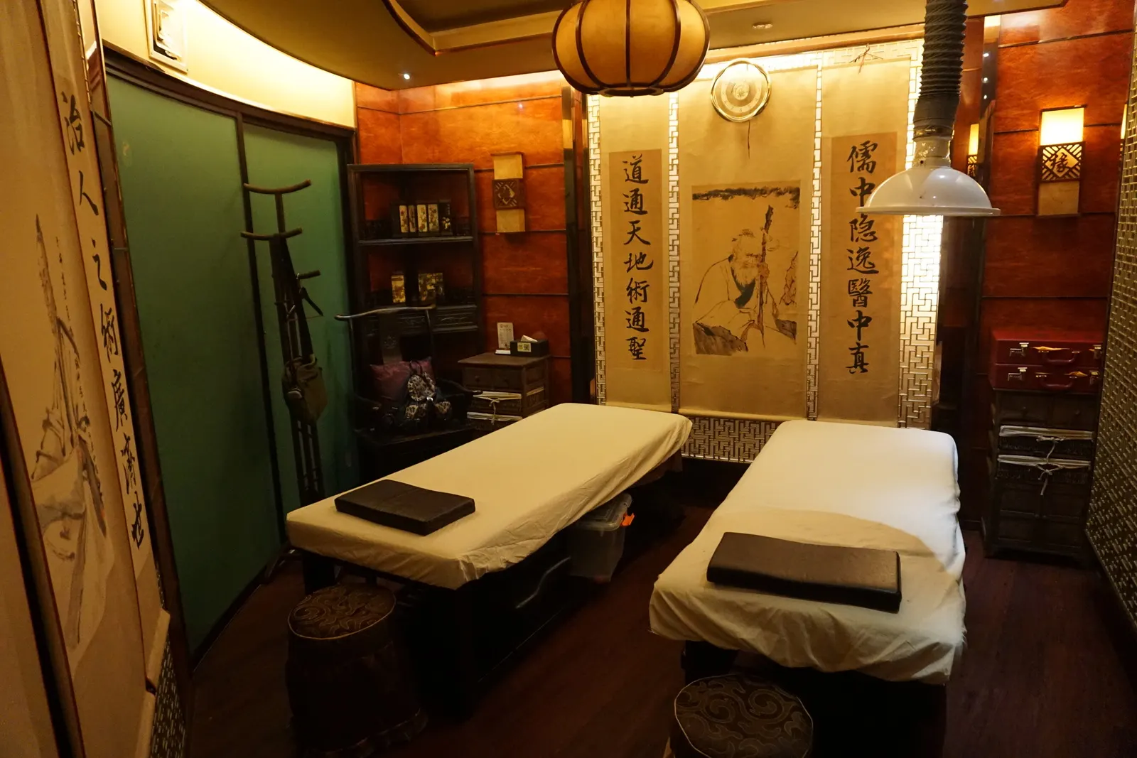 A massage treatment room in Shanghai with padded tables.