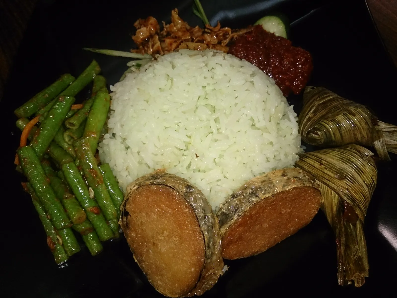 A vegetarian nasi lemak meal with rice, vegetables and a plant-based fish substitute.